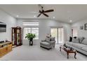 Bright living room with vaulted ceilings, neutral carpet, and a sliding glass door leading to the backyard at 2136 Eagle Sticks Dr. Dr, Henderson, NV 89012