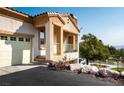 A cream colored stucco home featuring an attached two car garage and covered porch at 217 Big Horn Dr # 3, Boulder City, NV 89005
