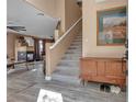 Entryway view of staircase, wood style tile floors, and modern fireplace feature at 223 Positive Point St, Henderson, NV 89012