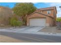 Charming two-story home with a well-maintained lawn and a two-car garage, showcasing curb appeal at 2504 Courlan Dr, North Las Vegas, NV 89084