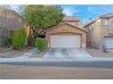 Charming two-story home with a well-maintained lawn and a two-car garage, showcasing curb appeal at 2504 Courlan Dr, North Las Vegas, NV 89084