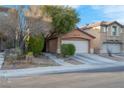 Charming two-story home with a well-maintained lawn and a two-car garage, showcasing curb appeal at 2504 Courlan Dr, North Las Vegas, NV 89084