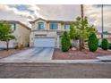 Traditional two-story home with a two-car garage, front yard landscaping, and inviting curb appeal at 3043 Jacaranda Dr, Las Vegas, NV 89117