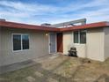 A single story home with desert landscaping, a security screen door, and desert landscaping at 310 E Lake Mead Blvd, North Las Vegas, NV 89030