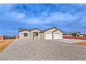 Inviting single-story home with a two-car garage, neutral exterior, and xeriscaped front yard for water conservation at 3120 S Torrey Pines Ave, Pahrump, NV 89048