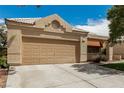 Inviting single-story house featuring a two-car garage and well-kept landscaping at 344 Mill Hollow Rd, Las Vegas, NV 89107