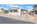 Charming single-story home featuring awnings, low fencing, and a well-maintained front yard at 3540 Estes Park Dr, Las Vegas, NV 89122