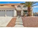 Inviting front entrance with double doors, meticulous landscaping, and a vibrant palm tree at 3604 N Campbell Rd, Las Vegas, NV 89129