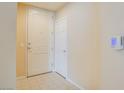 A clean and well-maintained entryway featuring neutral walls, tiled flooring, and a white entry door at 43 E Agate Ave # 305, Las Vegas, NV 89123