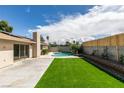 The backyard showcases a swimming pool, concrete patio, and artificial turf, perfect for outdoor enjoyment at 4855 San Sebastian Ave, Las Vegas, NV 89121