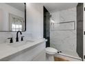 Modern bathroom featuring a luxurious walk-in shower with sleek black accents and a stylish vanity with black hardware at 4855 San Sebastian Ave, Las Vegas, NV 89121