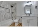 Bright bathroom features white vanity with black hardware and decorative tile shower with built-in niche at 4855 San Sebastian Ave, Las Vegas, NV 89121