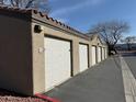 A row of detached garages feature white doors and red tiled roofs at 5055 W Hacienda Ave # 2175, Las Vegas, NV 89118