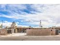 Street view showing a home's driveway with a wooden fence, offering both privacy and curb appeal at 5093 Sun Valley Dr, Las Vegas, NV 89122