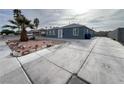 Street view of home with nice landscaping, long driveway and exterior paint at 524 Bedford Rd, Las Vegas, NV 89107