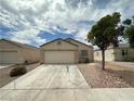 Single-story home with a well-maintained front yard, desert landscaping and a two car garage at 5433 Bridgehampton Ave, Las Vegas, NV 89130