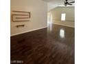 Open-concept living room featuring hardwood floors, vaulted ceilings, and a large window at 5433 Bridgehampton Ave, Las Vegas, NV 89130