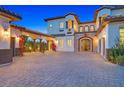 Elegant estate with a porte-cochere, stone accents, and a large paved driveway at 6 Rue Du Ville Way, Henderson, NV 89011
