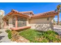 Close-up of a well-maintained home featuring a window box and desert landscaping at 620 Macbrey Dr, Las Vegas, NV 89123