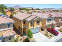 Aerial view of a residential community with mountain views and tile roofs at 6476 Ness Gardens Ct, Las Vegas, NV 89122