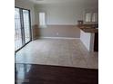 Open dining area with tile floors, sliding glass door, and adjacent to the kitchen island with granite countertops at 6476 Ness Gardens Ct, Las Vegas, NV 89122