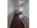 Inviting entryway featuring hardwood floors, decorative moldings, and natural lighting from the shuttered window at 6476 Ness Gardens Ct, Las Vegas, NV 89122