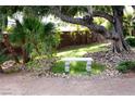 Serene backyard featuring a stone bench and lush greenery, ideal for relaxation at 6540 Tara Ave, Las Vegas, NV 89146