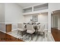 Dining room with a wood floor, decorative wainscoting, and modern chandelier at 6617 Golden Bit Ave, Las Vegas, NV 89131