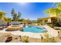 Inviting backyard pool and spa with desert landscaping and a covered patio, perfect for outdoor living at 6617 Golden Bit Ave, Las Vegas, NV 89131