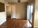 Dining room featuring wood flooring, a ceiling light fixture, and sliding glass doors to a balcony at 6955 Durango Dr # 3092, Las Vegas, NV 89149