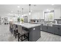 Bright kitchen with a large island, stainless steel appliances, and ample counter space at 6995 Rogers St, Las Vegas, NV 89118
