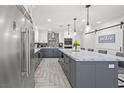 Spacious kitchen boasts an eat-in island, stainless steel appliances, and updated cabinetry at 6995 Rogers St, Las Vegas, NV 89118