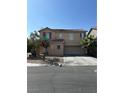 Charming two-story home featuring a neutral color palette, spacious driveway, and mature landscaping at 8089 Windmill Villa St, Las Vegas, NV 89139