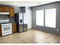 Well-lit kitchen featuring stainless steel refrigerator and tile flooring at 8089 Windmill Villa St, Las Vegas, NV 89139