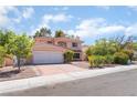 Charming two-story house with a well-maintained front yard, and tile roof at 9005 Feather River Ct, Las Vegas, NV 89117
