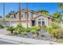 Inviting two-story home featuring lush landscaping and a spacious three-car garage at 950 Eagle Mountain Dr, Las Vegas, NV 89123