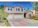 Charming two-story home with a three car garage, tile roof, and mature landscaping at 950 Eagle Mountain Dr, Las Vegas, NV 89123