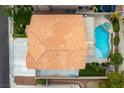 This aerial view showcases the home's terra cotta roof, swimming pool, and covered back patio at 9843 Frosty Canyon Ct, Las Vegas, NV 89183