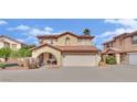 Two-story home featuring a red tile roof, arched entry, and a two-car garage against a sunny sky at , Las Vegas, NV 89139