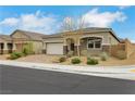 Charming single-story home with a two-car garage, desert landscaping, and a brick-paved driveway at 10161 Ocher Valley Ave, Las Vegas, NV 89178