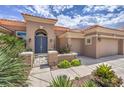 Charming home featuring a blue double-door entry, terracotta-colored roof, and mature landscaping at 10537 Shoalhaven Dr, Las Vegas, NV 89134