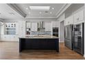 Spacious kitchen with stainless steel appliances, a wine fridge, a center island, and custom cabinets at 10537 Shoalhaven Dr, Las Vegas, NV 89134