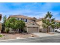 Charming two-story home features a two-car garage, desert landscaping, and a tile roof at 10657 Medicine Bow St, Las Vegas, NV 89183