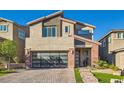 Charming two-story home featuring a contemporary design, brick accents, and manicured front yard with modern garage at 10936 White Alder Pl, Las Vegas, NV 89138