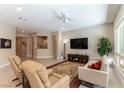 Inviting living room featuring tile floors, neutral walls, and ample natural light through a large picture window at 11161 Black Fire Opal Dr, Las Vegas, NV 89138
