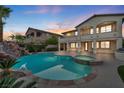 Resort-style backyard featuring a pool, spa, and covered patio, perfect for outdoor entertaining at 12283 Lost Treasure Ave, Las Vegas, NV 89138