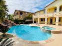 Inviting backyard featuring a sparkling pool, spa, and lush landscaping at 12283 Lost Treasure Ave, Las Vegas, NV 89138