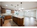Open-concept kitchen with island, stylish countertops, cabinetry, and seamless flow to the living area at 132 Soaring Sky Ave, Henderson, NV 89011