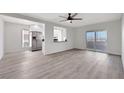 Open concept living room features wood-look floors, updated lighting, and opens to the modern kitchen at 1405 Vegas Valley Dr # 312, Las Vegas, NV 89169