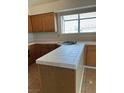 Kitchen island with tiled countertop, sink, and ample storage underneath at 149 Cologne Ct, Henderson, NV 89074